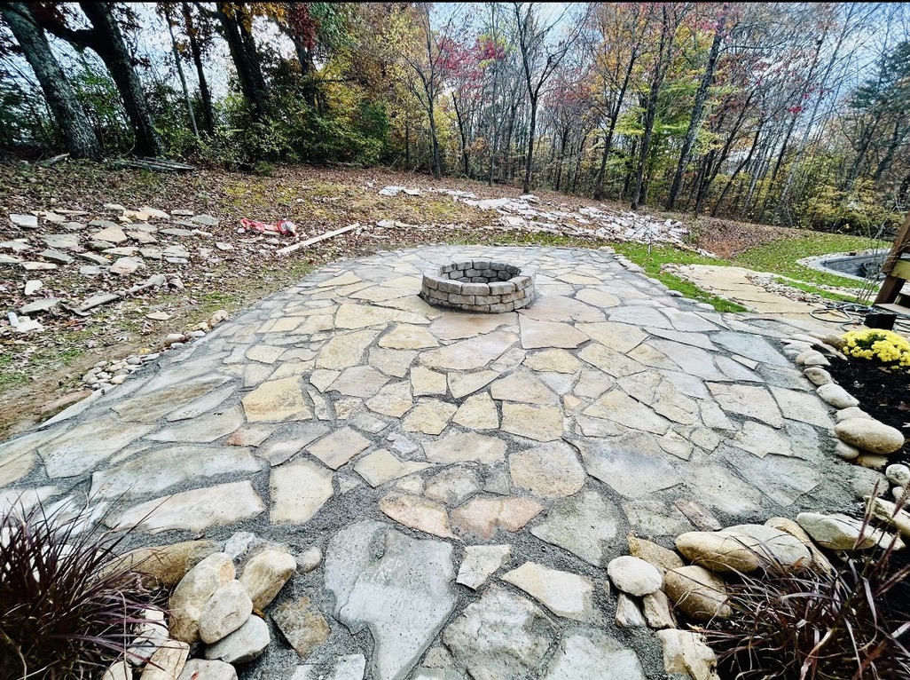 Completed flagstone patio with a circular stone fire pit