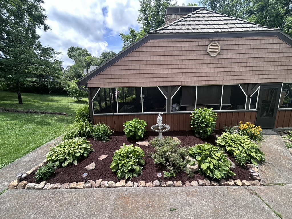 Garden beside screened porch after weeding and mulching